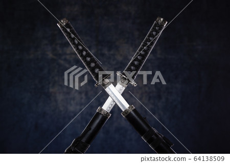Two crossed katanas with partially drawn blades 64138509