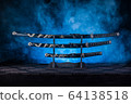 Three swords on stand, blue smoke behind 64138518