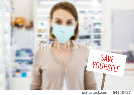 Young woman wearing mask and looking serious Young woman wearing mask and looking serious 64138727