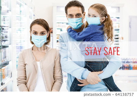 Attentive masked family caring for their safety 64138757
