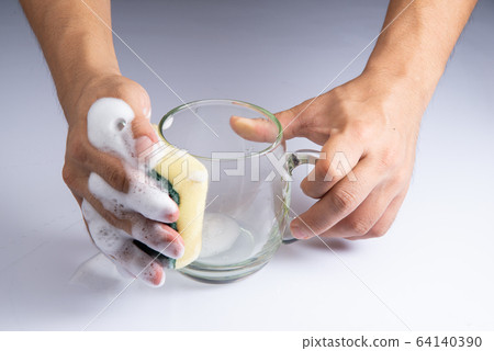 washing clear glass by bare hand and sponge foam on white background stock photo 64140390