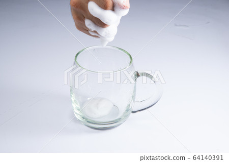 washing clear glass by bare hand and sponge foam on white background stock photo washing clear glass by bare hand and sponge foam on white background stock photo 64140391