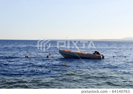 The inflatable gray fast boat, a motor boat  64140763