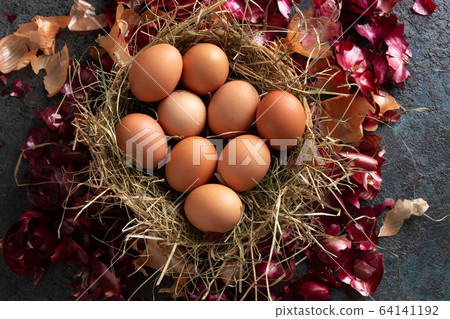 Raw eggs in a basket, ready to be dyed with onion skins Raw eggs in a basket, ready to be dyed with onion skins 64141192