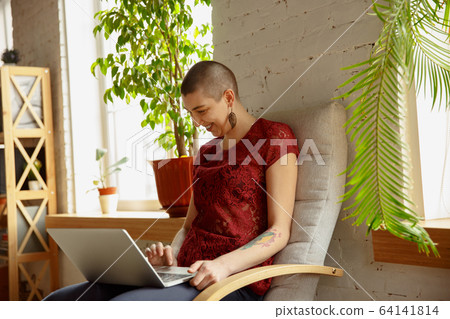 Woman working from home during coronavirus or COVID-19 quarantine, remote office concept Woman working from home during coronavirus or COVID-19 quarantine, remote office concept 64141814