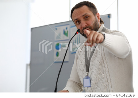 Male person speaking into microphone 64142169