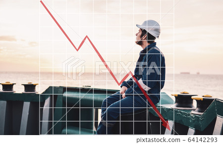 Concept of falling market in marine industry with downward graphics. Marine Deck Officer or Chief mate on deck Concept of falling market in marine industry with downward graphics. Marine Deck Officer or Chief mate on deck 64142293