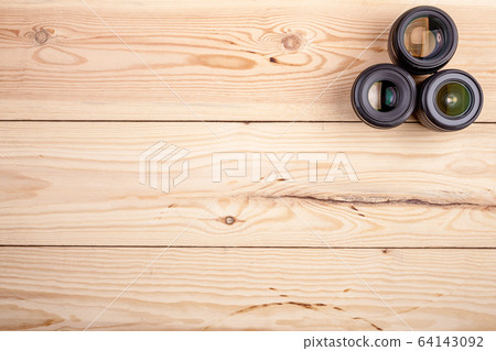 camera lenses on wooden table top view. background and workspace for photography 64143092