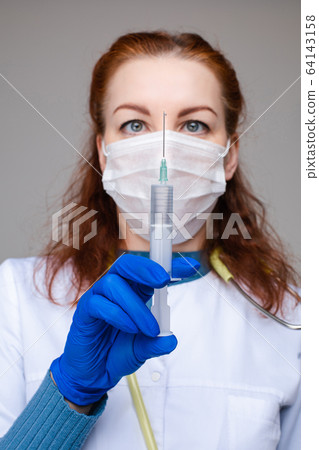 Doctor with syringe filled with vaccine. fighting Doctor with syringe filled with vaccine. fighting 64143158