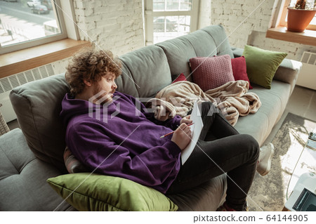 Man working from home during coronavirus or COVID-19 quarantine, remote office concept 64144905