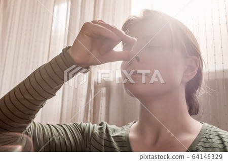 Yoga girl practicing nadi shodhana pranayama or Alternate, Nostril, Breathing 64145329