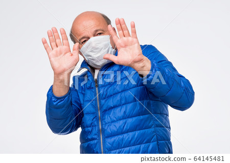 senior sick old man in medical mask being afraid to be ill by coronavirus. senior sick old man in medical mask being afraid to be ill by coronavirus. 64145481