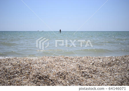 Surfer with paddle board catching the wave. Surfer with paddle board catching the wave. 64146071