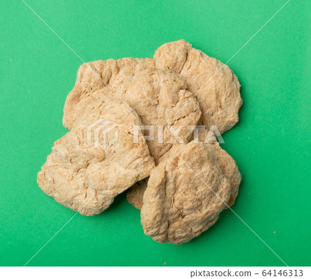 Raw Dehydrated Soy Meat or Soya Chunks on Green 64146313