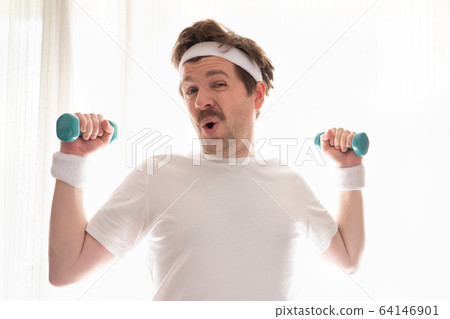 Funny mature man exercising at home holding weights Funny mature man exercising at home holding weights 64146901