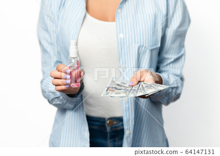 Woman Holding Money And Sanitizer Standing Over White Background, Cropped Woman Holding Money And Sanitizer Standing Over White Background, Cropped 64147131