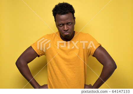 African displeased, angry, grumpy and pissed off male frowning at camera African displeased, angry, grumpy and pissed off male frowning at camera 64147133