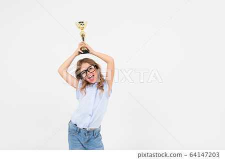 champion girl holds a winner cup on a white background with copy space champion girl holds a winner cup on a white background with copy space 64147203