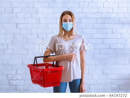 Grocery shopping during coronavirus concept. Girl with basket 64147272