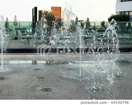 A small singing fountain in the open air, on A small singing fountain in the open air, on 64148746