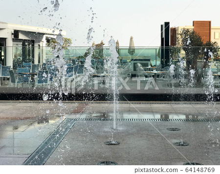 A small beautiful singing fountain in the open A small beautiful singing fountain in the open 64148769