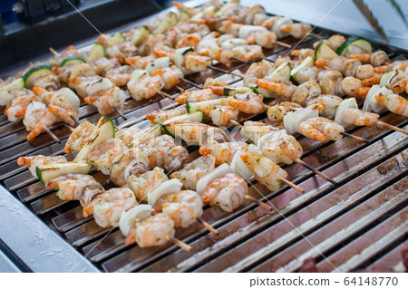 Close up of barbecue grill with delicious prawns. Close up of barbecue grill with delicious prawns. 64148770
