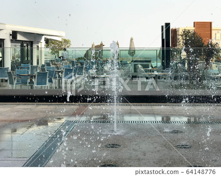 A small beautiful singing fountain in the open A small beautiful singing fountain in the open 64148776