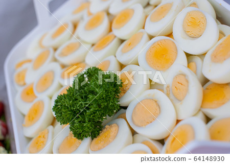 Bunch of sliced hard boiled eggs 64148930