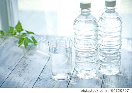 PET bottles and cups with water 64150797