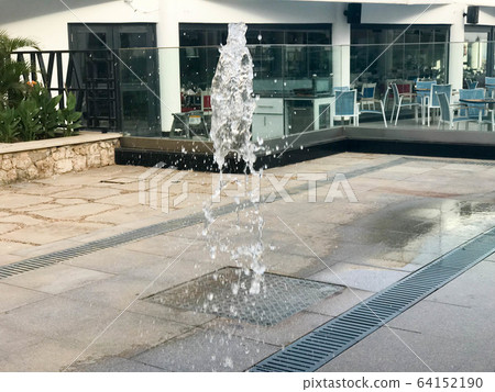 A small beautiful singing fountain in the open  64152190