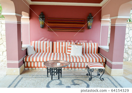 Soft sofa in an outdoor cafe on the street Soft sofa in an outdoor cafe on the street 64154329