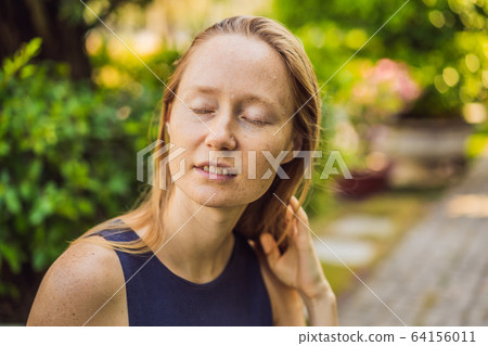 I love my skin. A young woman with freckles, moles, scars and facial wrinkles loves her skin, enjoys I love my skin. A young woman with freckles, moles, scars and facial wrinkles loves her skin, enjoys 64156011