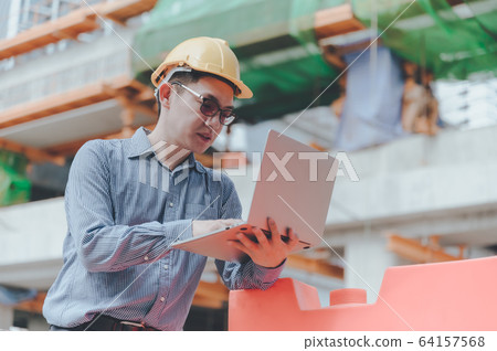 Young asian engineers are working on the construction site Young asian engineers are working on the construction site 64157568