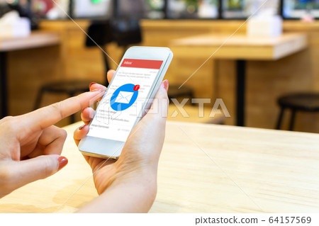 Hand of female checking application email on smart phone Hand of female checking application email on smart phone 64157569
