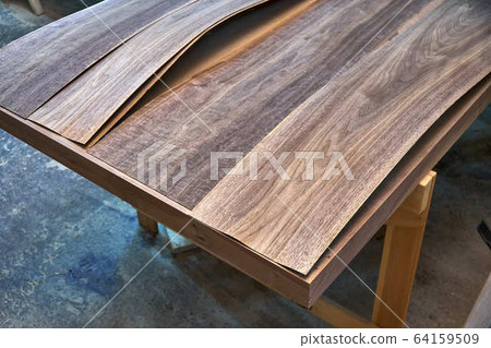Walnut veneer. Wood texture. Woodworking and carpentry production Walnut veneer. Wood texture. Woodworking and carpentry production 64159509