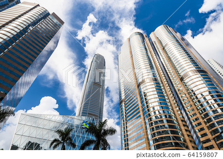 low angle view of modern office block buildings in Hong Kong. International Finance Center(IFC) in Hong Kong. low angle view of modern office block buildings in Hong Kong. International Finance Center(IFC) in Hong Kong. 64159807