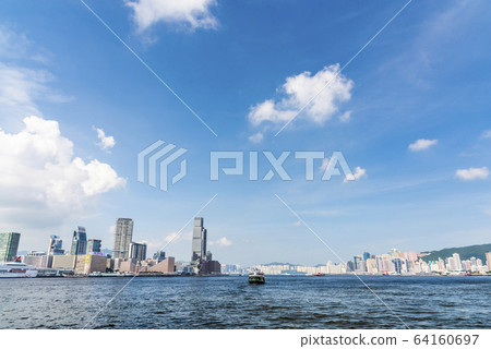 City skyline view of Tsim Sha Tsui across Victoria Harbour with city lights of Hong Kong Cultural Center, Clock Tower and Star Ferry piers City skyline view of Tsim Sha Tsui across Victoria Harbour with city lights of Hong Kong Cultural Center, Clock Tower and Star Ferry piers 64160697