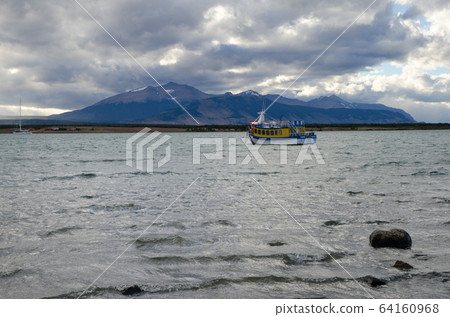 Tourist boat in the Ultima Esperanza Inlet from Puerto Natales. Tourist boat in the Ultima Esperanza Inlet from Puerto Natales. 64160968
