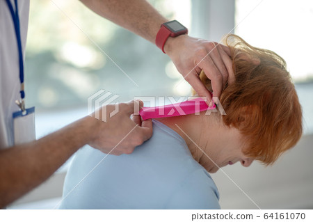 Professional skilled doctor using a special band Professional skilled doctor using a special band 64161070