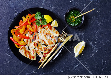 Grilled chicken tenders with peppers, top view 64161141