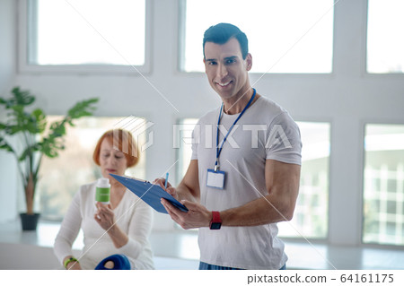 Delighted positive male doctor smiling to you Delighted positive male doctor smiling to you 64161175