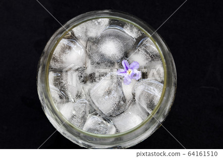background texture iced ,water in glass with purple flower decoration postcard style on black background texture iced ,water in glass with purple flower decoration postcard style on black 64161510