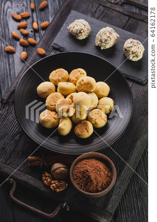 Delicious homemade chocolate chip cookies balls on a black wooden background. Delicious homemade chocolate chip cookies balls on a black wooden background. 64162178