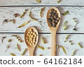 Herbal pills and dry herbs on wooden background. 64162184