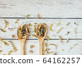 Natural organic herbal green tea in wooden spoons. 64162257