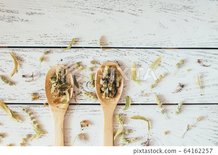 Natural organic herbal green tea in wooden spoons. Natural organic herbal green tea in wooden spoons. 64162257