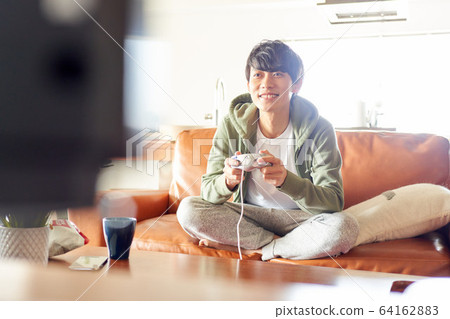 Men playing games in the room Men playing games in the room 64162883