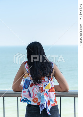 Woman relax at sea viewpoint in concept travel Woman relax at sea viewpoint in concept travel 64163125