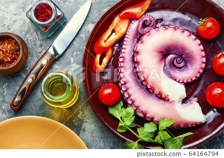 Raw octopus on plate Raw octopus on plate 64164794