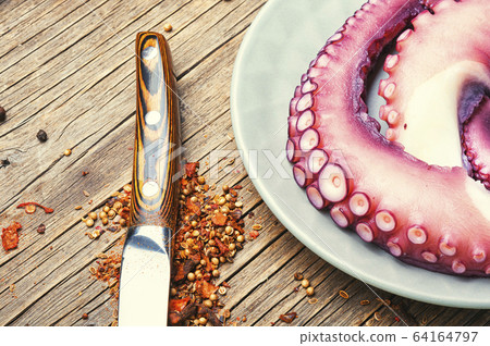 Raw uncooked octopus on wooden table Raw uncooked octopus on wooden table 64164797